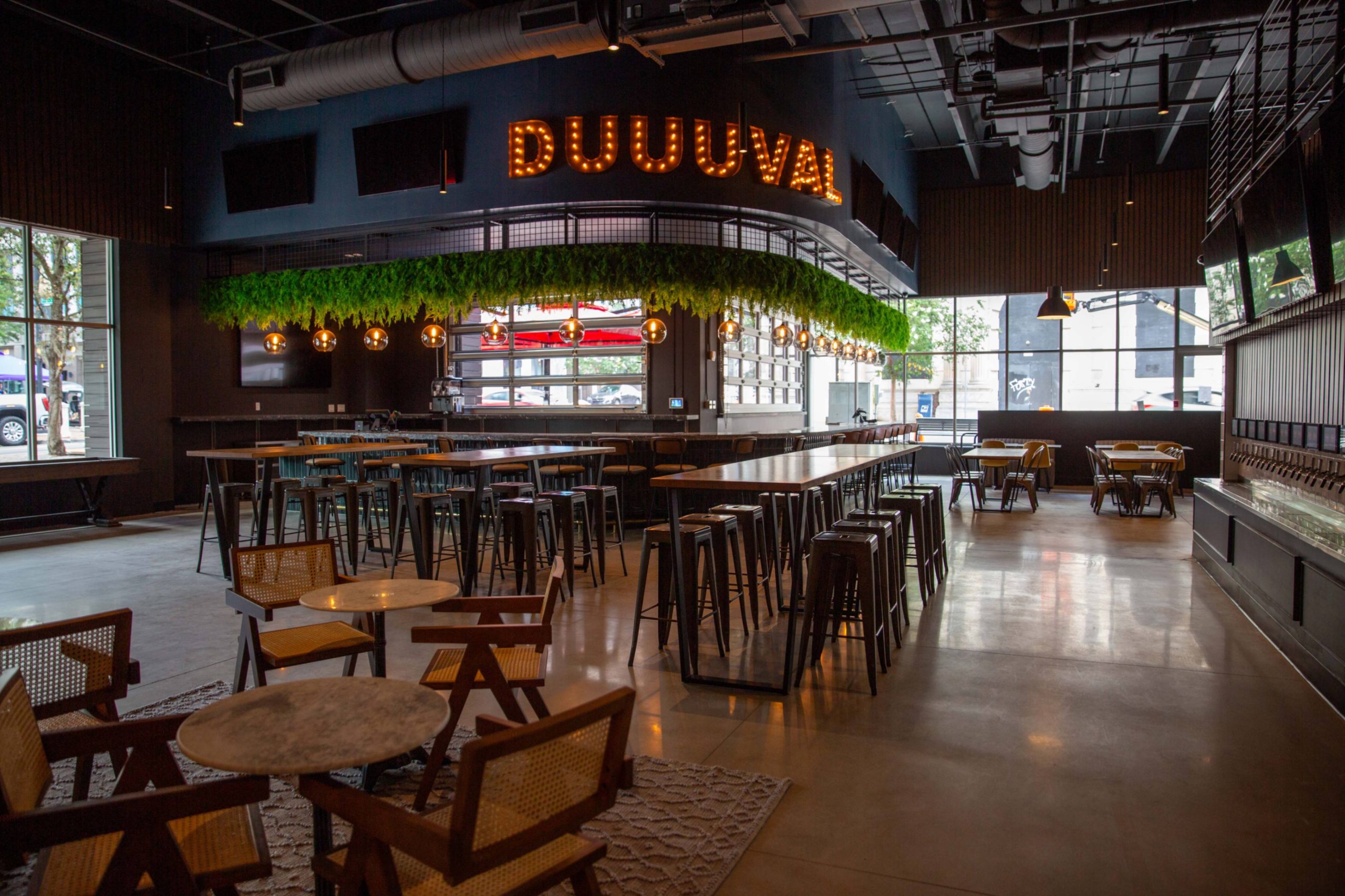 Main floor of Pour Taproom Jacksonville under the Duuuval sign