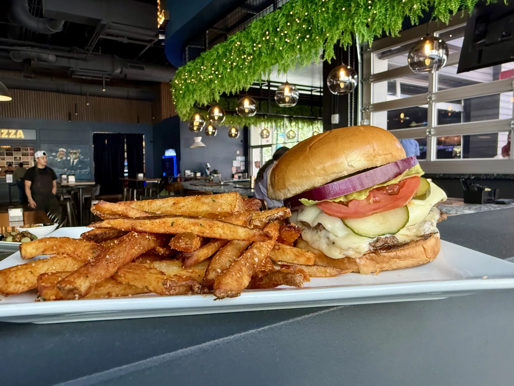 Burger and fries inside Pour Taproom in Downtown Jacksonville