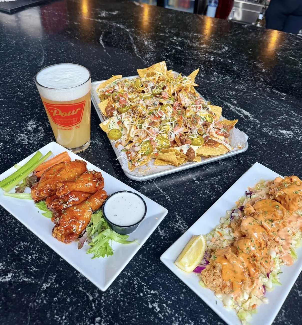 Wings, nachos and a draft beer at Pour Taproom Jacksonville