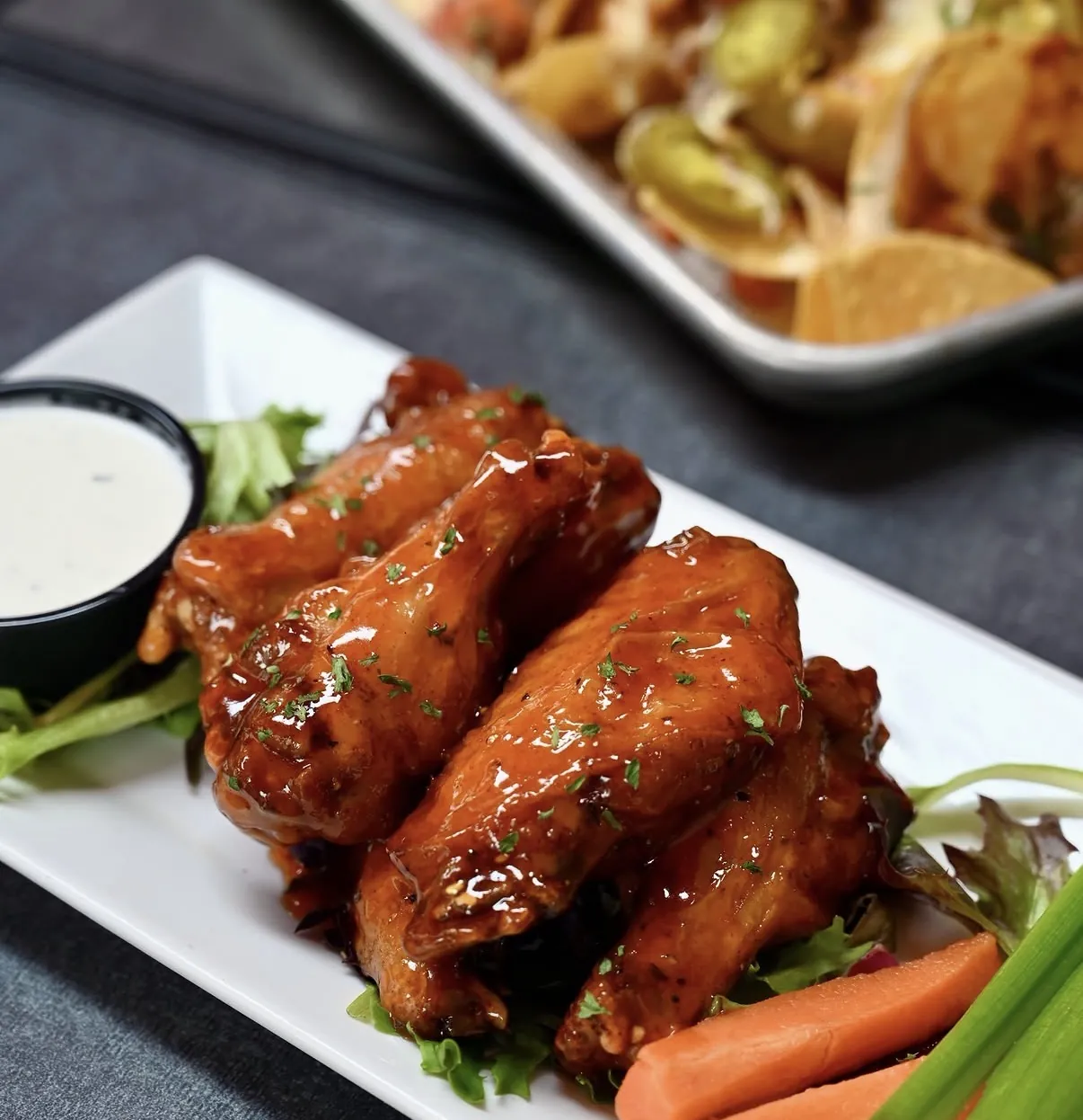 Glazed wings with celery and carrots at Pour Taproom Jacksonville